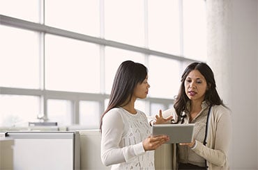 a photograph of two women talking